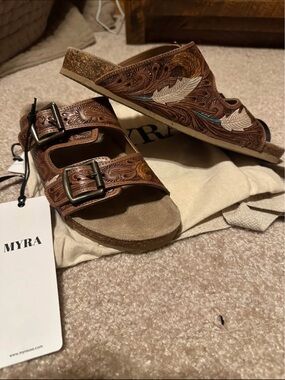 Myra Brand 
Brown Leather Double-Buckle Sandals with Embossed Feather Detail